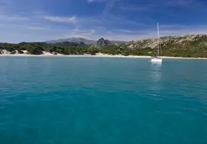 Crag Prints: France, Corsica. Sailboat anchored in clear water off white sand of Saleccio Beach