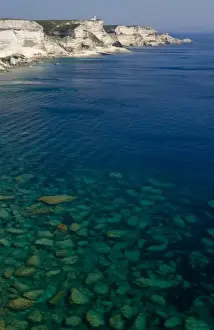 France, Corsica. View of white limestone cliffs and clear water of Mediterrean Sea from Bonifacio