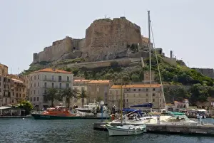 Citadel Prints: France, Corsica. Walled citadel enclosing the old city rises above the inner harbor at Bonifacio