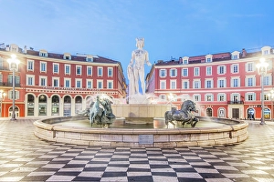 Provence Prints: France, Cote d Azur, Nice. Sun Fountain at Place Massena with Statue of Apollo at dawn