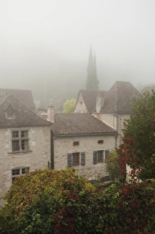 Images Dated 27th October 2010: France, Midi-Pyrenees Region, Lot Department, St-Cirq-Lapopie, town overview in fog