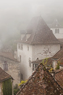Images Dated 27th October 2010: France, Midi-Pyrenees Region, Lot Department, St-Cirq-Lapopie, town overview in fog