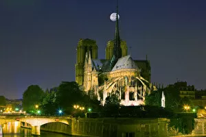 France, Paris. Full moon over Notre Dame Cathedral at night