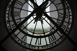 France, Paris. View across Seine River through transparent face of one of the clocks