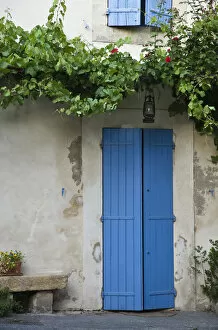 France, Provence, Lourmarin. Blue shutters cover a doorway to a home