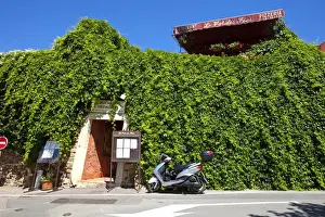 Motorcycle Prints: France, Provence, Roussillon. Motorcycle outside restaurant entrance. Credit as