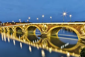 France, Toulouse. View of Pont Neuf and the Garonne River and reflections at sunset
