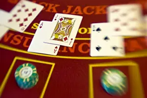 French Polynesia. Black jack hands and poker chips on a casino table aboard Paul Gaugin cruise ship