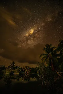French Polynesia, Taha'a. Palm trees and night sky with Milky Way