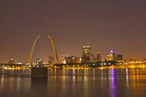 City Light Prints: The Gateway Arch and St Louis skyline reflect into the Mississippi River at dusk in St Louis