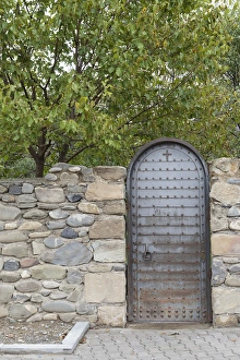 Images Dated 20th September 2014: Georgia, Mtskheta. A metal door and rock wall