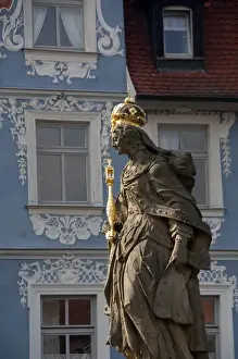 Germany, Bamberg. Royal statue of Kaiserin Kunigund in front of ornate blue & white