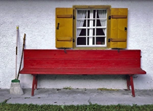 Broom Prints: Germany, Bavaria, Almbachklamm. A bright red bench welcomes visitors to this home