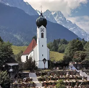 Church Tower Prints: Germany, Bavaria, Obergrainau. Well-tended grave sites mark the entrance to the church
