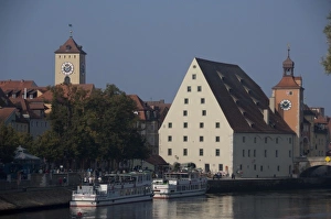 Germany, Bavaria, Regensburg. Historic Salt House, clock tower on the banks of the Danube River