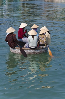 Paddle Prints: Girl with conical hat in bamboo made basket boat