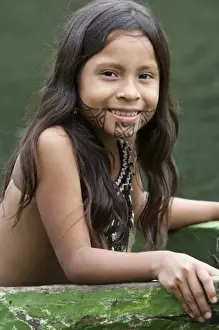 Goa, Panama. Panama, Young Wounaan Indian girl riding in a hand carved canoe. (MR)