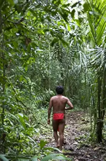 Future Prints: Goa, Panama. A young Wounaan Indian man walking in the rain forest of Panama. (MR)