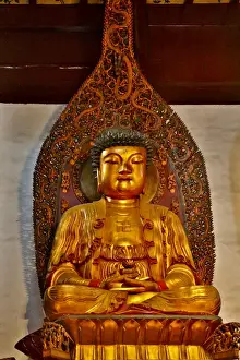 Golden and colorful Buddas at the Jade Buddha Temple in Shanghai, China