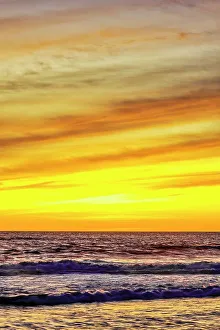 Cloudscape Prints: The golden light of the setting sun reflects a gold glow on the beach at Pererenan Beach