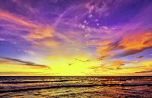 Cloudscape Prints: The golden light of the setting sun reflects a gold glow on the beach at Pererenan Beach