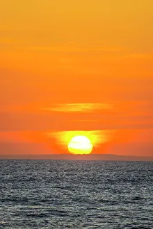 Images Dated 5th January 2023: The golden light of the setting sun reflects a gold glow on the beach at Pererenan Beach