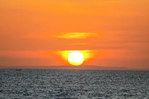 Images Dated 5th January 2023: The golden light of the setting sun reflects a gold glow on the beach at Pererenan Beach