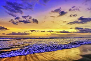 Images Dated 5th January 2023: The golden light of the setting sun reflects a gold glow on the beach at Pererenan Beach