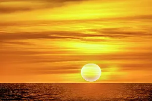 Cloudscape Prints: The golden light of the swirling clouds sunset reflects a pink glow on the beach at Pererenan Beach