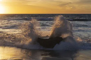 Crashing Prints: Golden sunset light coming through the white water crashing off a rock