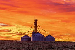 Grain bins silhouetted at sunrise Clay County, Illinois