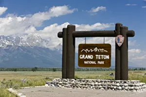 Cloudy Prints: Grand Teton National Park welcome sign with the Grand Teton mountains in the background
