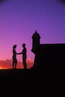 Graphic colorful sunset couple at El Morro Fort in Old San Juan, Puerto Rico
