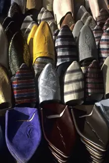 Shoe Prints: Graphic image of Morocco shoes stacked for sale on streets in Casablanca Morocco Africa