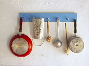 Images Dated 12th September 2018: Greece, Corfu. Kitchen utensils hang on rack