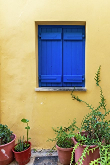 Images Dated 1st June 2024: Greece, Crete, Chania harbor, old town. Blue shutters in yellow wall