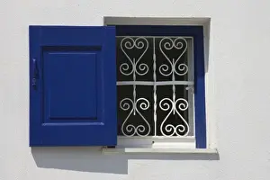 Hora Prints: Greece, Mykonos, Hora. Open window with blue shutter and iron grill contrast with white wall