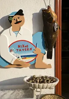Hora Prints: Greece, Mykonos, Hora. Sign at entrance to Nikos Tavern beside hanging fish