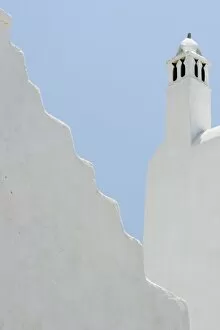 Images Dated 30th May 2005: Greece, Mykonos, Hora. Whitechurch belfry against light blue sky and irregular wall