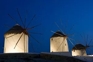 Images Dated 29th May 2005: Greece, Mykonos, Hora. Three windmills lit at sunset