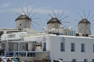 Greece, Mykonos, Hora. Zorbas restaurant with windmills in background