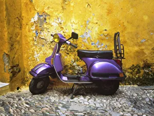 Greece, Rhodes. Vespa motorbike and colorful house exterior