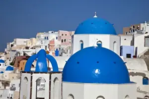 Images Dated 20th May 2009: Greece, Santorini. Bell tower and blue domes of church in village of Oia