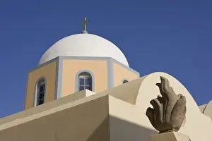 Greek Orthodox Prints: Greece, Santorini. Church dome against blue sky with small sculpture in foreground