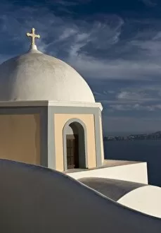 Images Dated 5th June 2005: Greece, Santorini. Church dome against clouds and blue sky with Aegean Sea in background