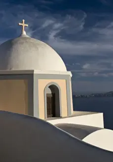 Greek Orthodox Prints: Greece, Santorini. Church dome against clouds and blue sky with Aegean Sea in background