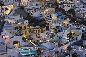 Images Dated 4th June 2005: Greece, Santorini, Firostefani. Close-up of cliffside villas with lights coming on at nightfall
