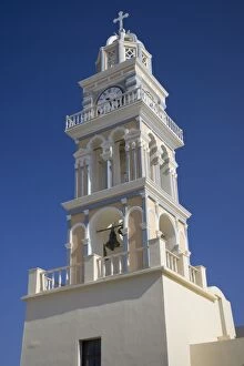Greece, Santorini. Ornate church clock tower against clear blue sky