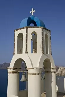 Images Dated 9th June 2005: Greece, Santorini, Thira, Oia. Greek Orthodox church bell tower with cross overlooking sea