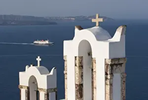 Images Dated 9th June 2005: Greece, Santorini, Thira, Oia. Two Greek Orthodox church bell towers and a Hellenic